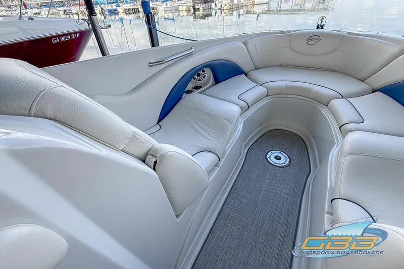 Slide: The Image of 2009 Crownline 300 LS boat interior with white seating and blue accents. - 14