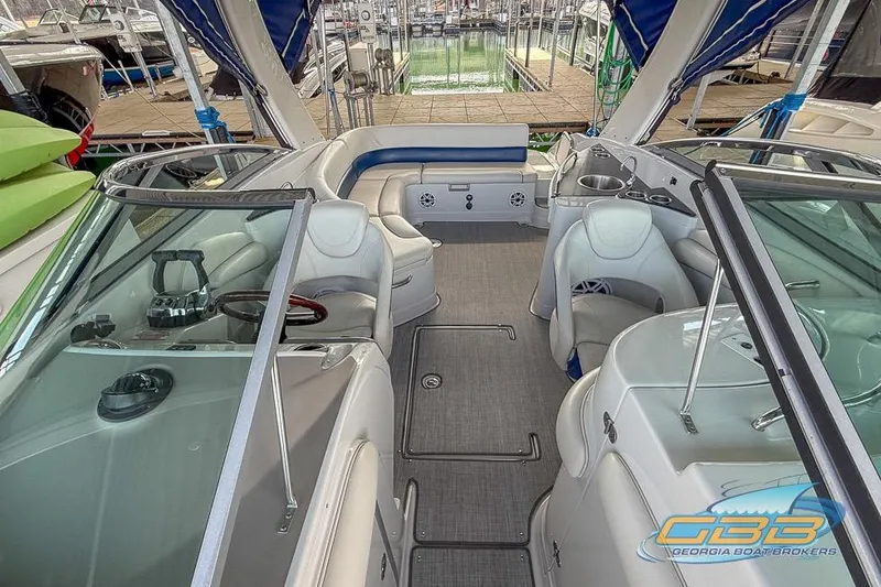 Slide: The Image of 2009 Crownline 300 LS boat interior with seating and helm, docked at marina. - 18