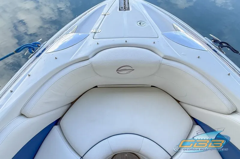 Slide: The Image of 2009 Crownline 300 LS boat bow with white seating and blue accents on water. - 22