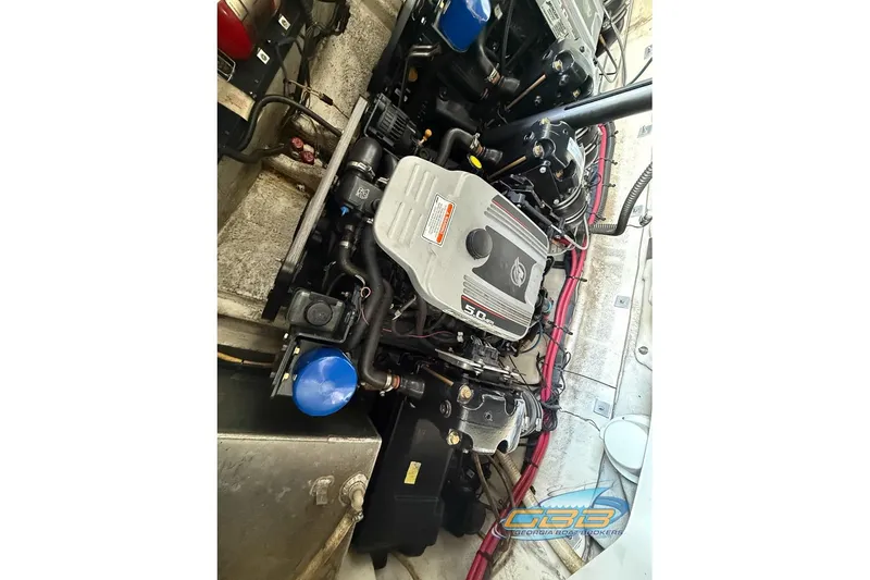 Slide: The Image of Engine compartment of 2009 Crownline 300 LS boat, featuring a 5.0L engine. - 25