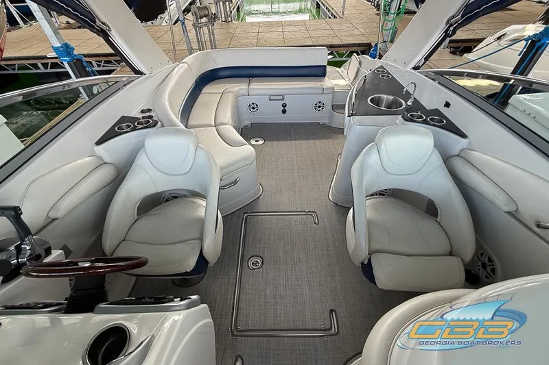 Slide: The Image of 2009 Crownline 300 LS boat interior with seating, steering wheel, and sink. - 3