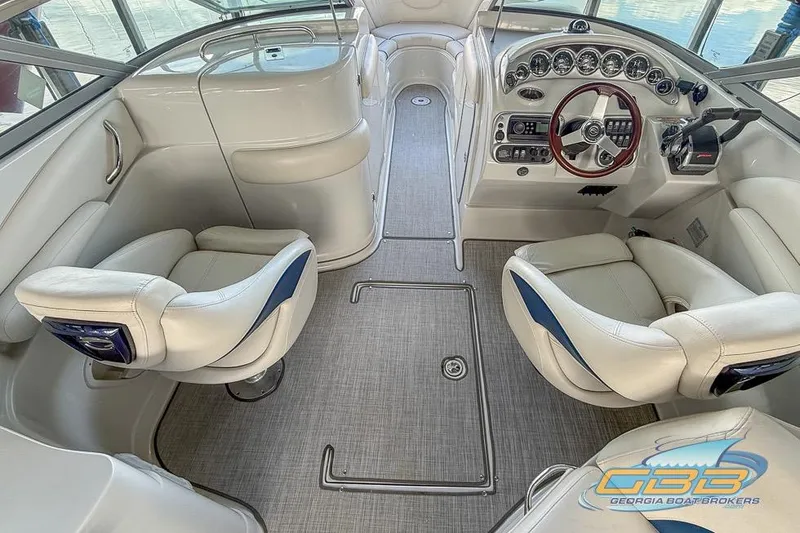 Slide: The Image of Interior of a 2009 Crownline 300 LS boat with white seating and modern dashboard. - 9