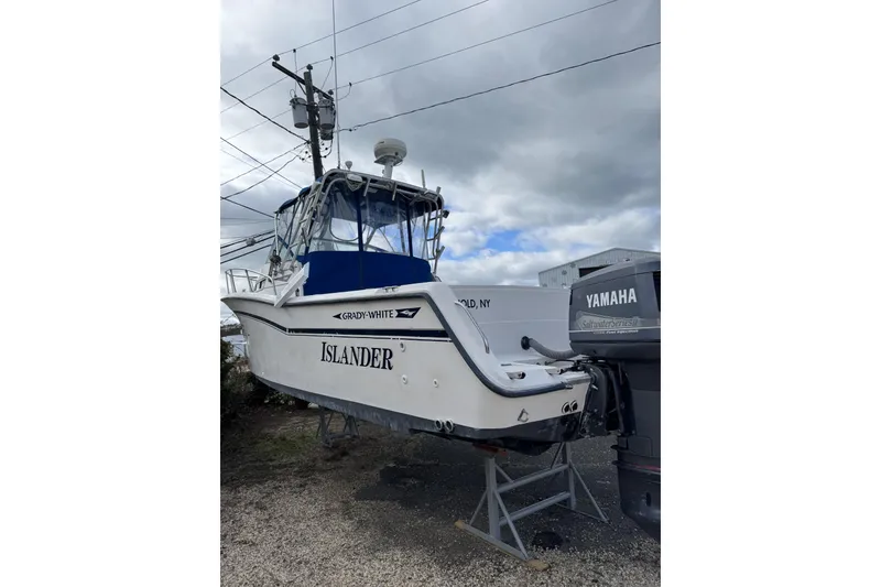 The Image of 1989 Grady White 30 Marlin boat on stand, featuring Yamaha outboard motor. - 0