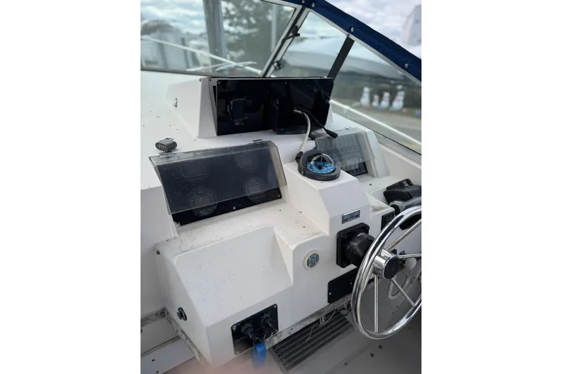 Slide: The Image of 1989 Grady White 30 Marlin boat dashboard with steering wheel and compass. - 2