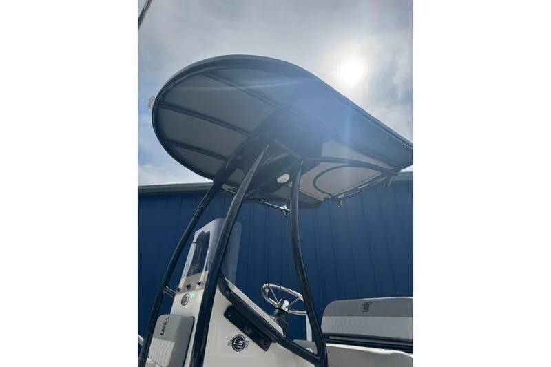 Slide: The Image of 2026 Carolina Skiff 21 LS boat with T-top under sunny sky. - 2