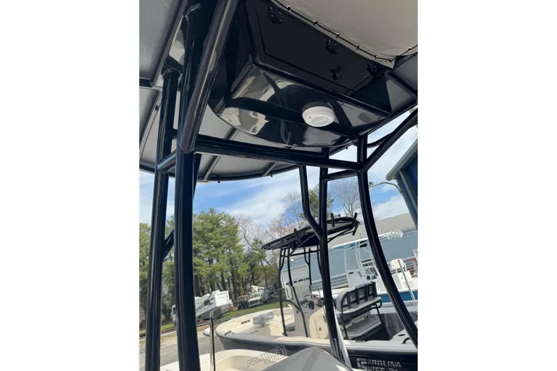 Slide: The Image of 2026 Carolina Skiff 21 LS boat with T-top frame, outdoor setting. - 5