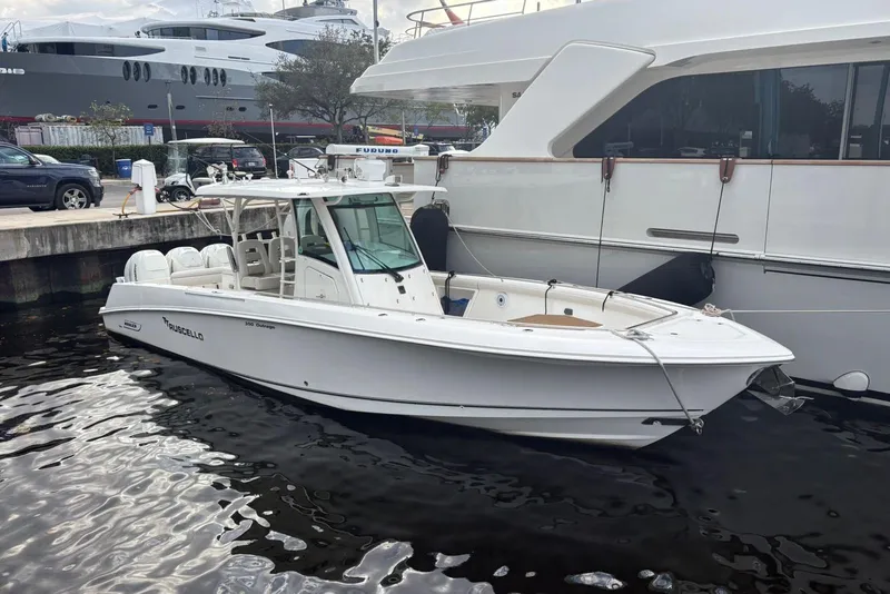 Slide: The Image of 2017 Boston Whaler 350 Outrage boat docked beside a larger yacht. - 3