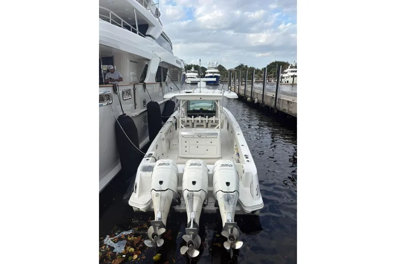 Slide: The Image of 2017 Boston Whaler 350 Outrage docked with triple outboard engines. - 4