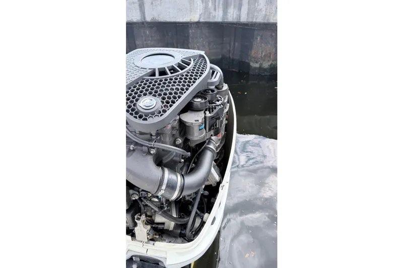 Slide: The Image of 2017 Boston Whaler 350 Outrage engine detail near water. - 8