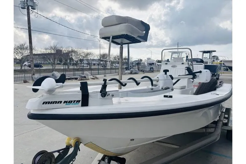 Slide: The Image of Kenner Vision 1800 boat, 2008 model, with Minn Kota motor, parked outdoors. - 10