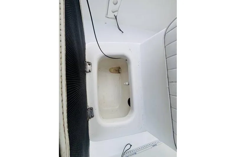 Slide: The Image of Interior compartment of a 2008 Kenner Vision 1800 boat, featuring storage space. - 11