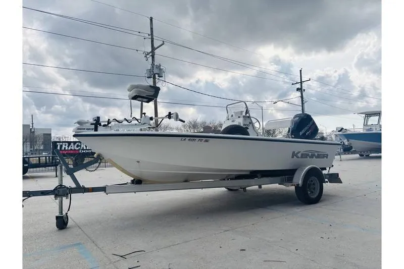 Slide: The Image of 2008 Kenner Vision 1800 boat on trailer under cloudy sky. - 12