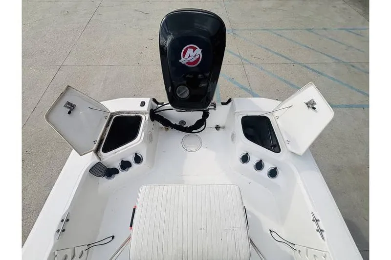 Slide: The Image of 2008 Kenner Vision 1800 boat interior with open storage compartments and motor. - 4