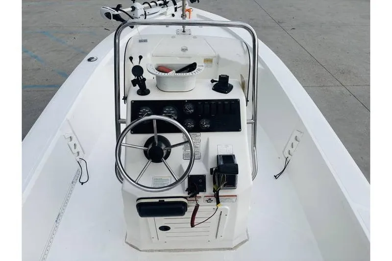 Slide: The Image of Center console of a 2008 Kenner Vision 1800 boat with steering wheel and controls. - 7