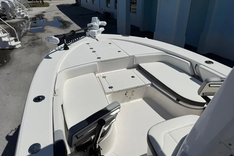 Slide: The Image of 2023 Robalo 246 Cayman SD boat interior with seating and storage compartments. - 11