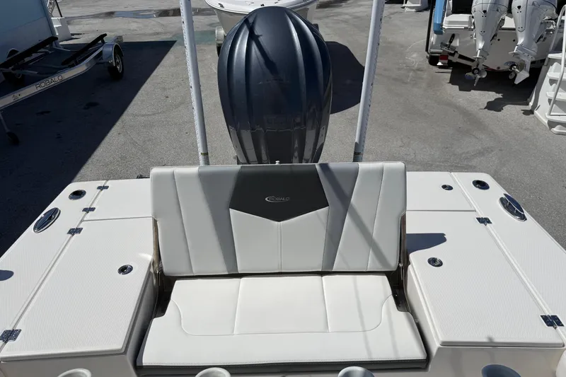 Slide: The Image of 2023 Robalo 246 Cayman SD boat interior with seating and engine view. - 12