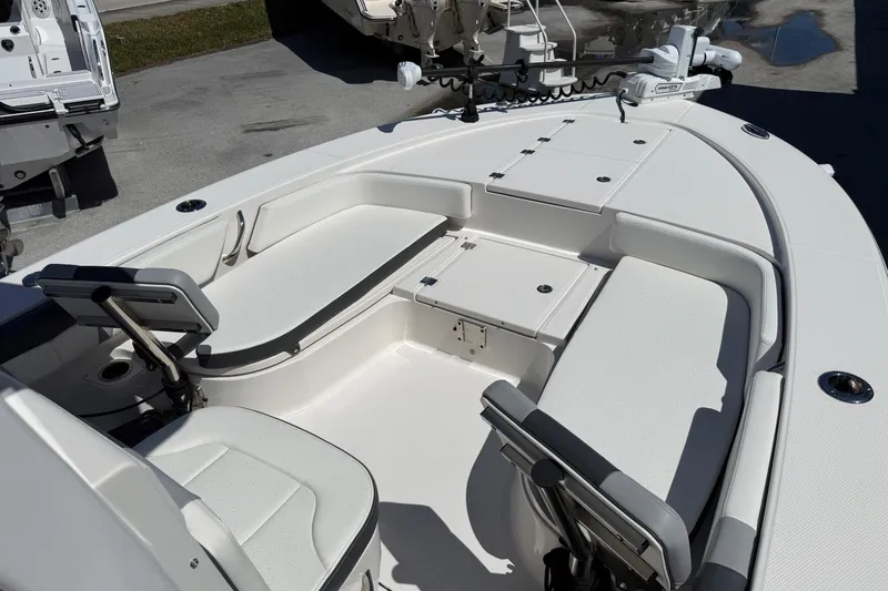 Slide: The Image of 2023 Robalo 246 Cayman SD boat interior with seating and storage compartments. - 14