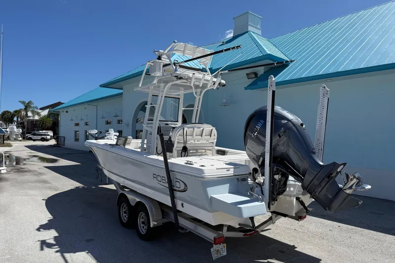 Slide: The Image of 2023 Robalo 246 Cayman SD boat with Yamaha outboard motor on trailer. - 4