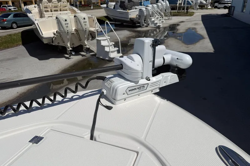Slide: The Image of 2023 Robalo 246 Cayman SD with Minn Kota trolling motor in a boatyard. - 8