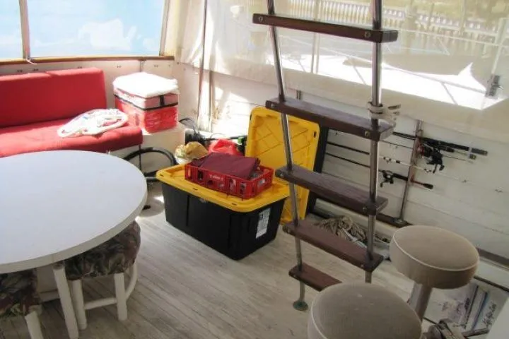 Slide: The Image of Interior of 1973 Chris-Craft 55 Commander with seating, storage boxes, and ladder. - 12