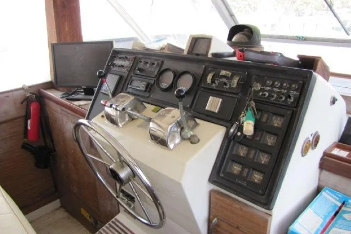 Slide: The Image of 1973 Chris-Craft 55 Commander helm with steering wheel, gauges, and control panels. - 17