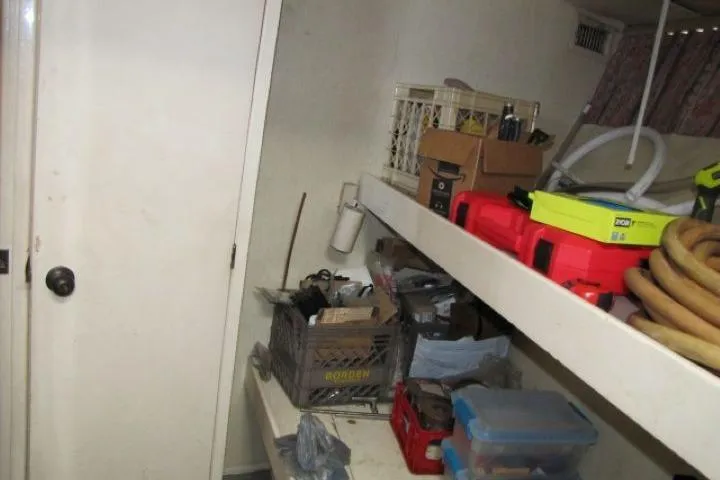 Slide: The Image of Storage area on a 1973 Chris-Craft 55 Commander with shelves and various tools. - 32