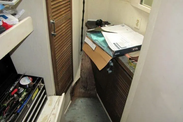 Slide: The Image of Interior of a 1973 Chris-Craft 55 Commander with cluttered storage area. - 35