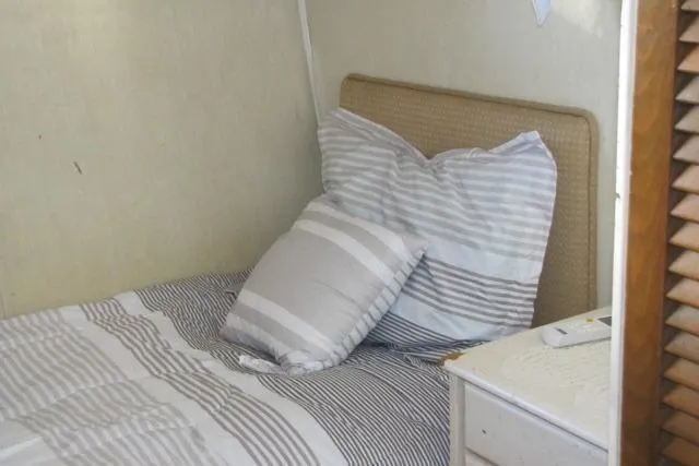 Slide: The Image of Cozy bedroom interior on 1973 Chris-Craft 55 Commander yacht with striped bedding. - 38
