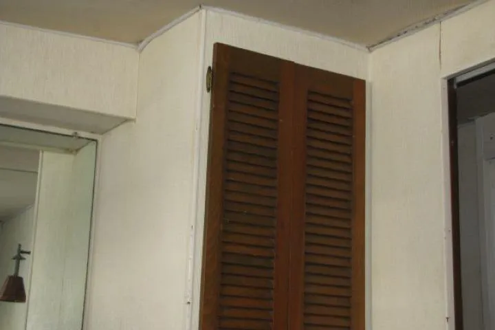 Slide: The Image of Wooden louvered door inside a 1973 Chris-Craft 55 Commander yacht. - 42