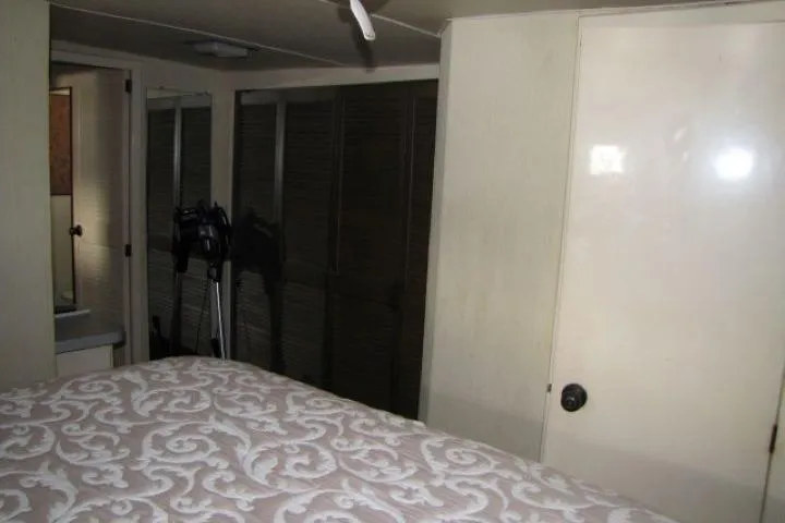 Slide: The Image of Interior of 1973 Chris-Craft 55 Commander with bed, closet, and door. - 48