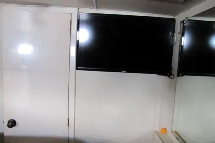 Slide: The Image of Interior of 1973 Chris-Craft 55 Commander with wall-mounted TV and door. - 49