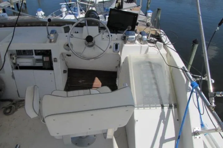 Slide: The Image of 1973 Chris-Craft 55 Commander helm with steering wheel, controls, and navigation equipment. - 5
