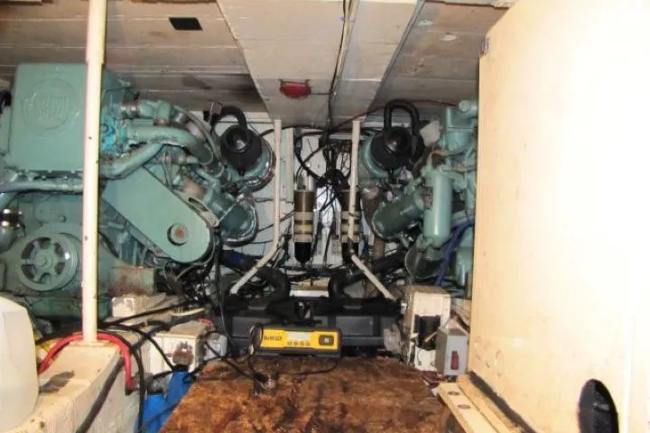 Slide: The Image of Engine room of a 1973 Chris-Craft 55 Commander with dual engines and mechanical components. - 56