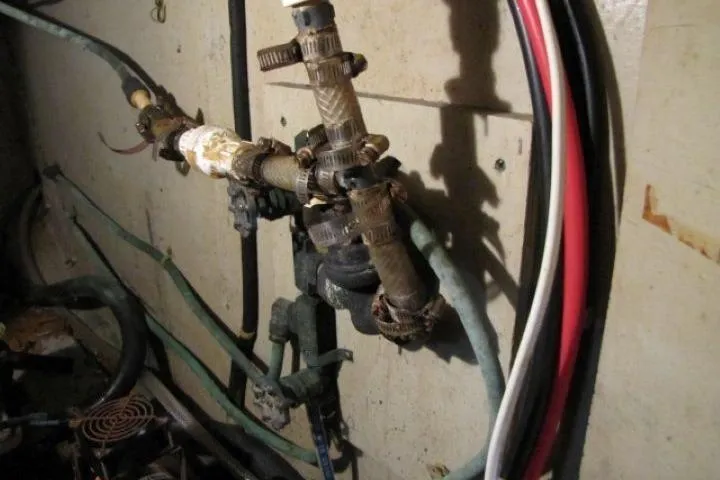 Slide: The Image of Old plumbing system in a 1973 Chris-Craft 55 Commander boat. - 58