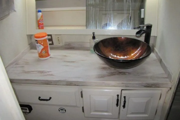 Slide: The Image of 1973 Chris-Craft 55 Commander bathroom with vessel sink and marble countertop. - 61