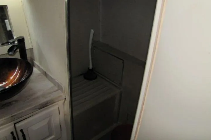 Slide: The Image of 1973 Chris-Craft 55 Commander bathroom with sink and compact shower area. - 63