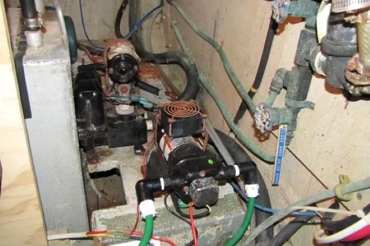 Slide: The Image of Engine room of a 1973 Chris-Craft 55 Commander with visible machinery and wiring. - 68