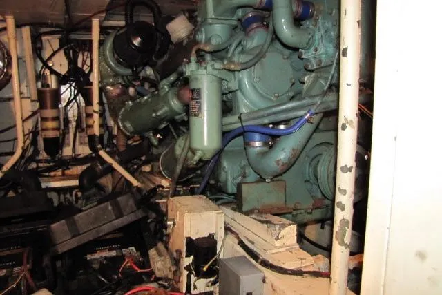 Slide: The Image of Engine room of a 1973 Chris-Craft 55 Commander with visible machinery and wiring. - 74