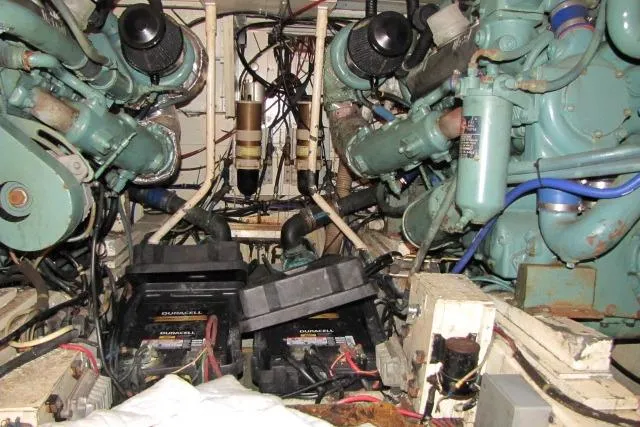 Slide: The Image of Engine room of a 1973 Chris-Craft 55 Commander with visible batteries and wiring. - 75