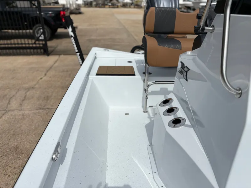 Slide: The Image of 2026 Xpress H210B boat with modern seating and fishing rod holders. - 7