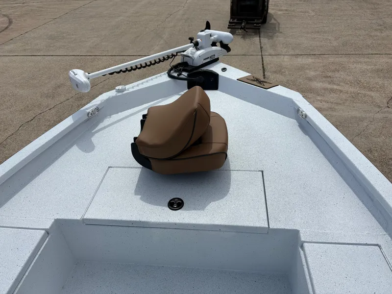 Slide: The Image of 2026 Xpress H20B boat with brown seat and Minn Kota motor. - 7