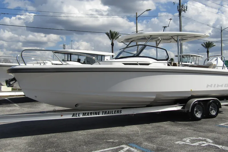 Slide: The Image of Nimbus Tender 9 boat 2026 on trailer, cloudy sky. - 7