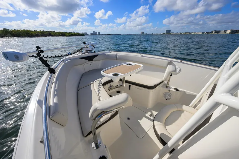 Slide: The Image of 2022 Sailfish 242 CC boat interior with seating and table on open water. - 13