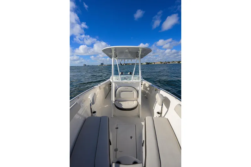 Slide: The Image of 2022 Sailfish 242 CC boat interior on open water under blue sky. - 19