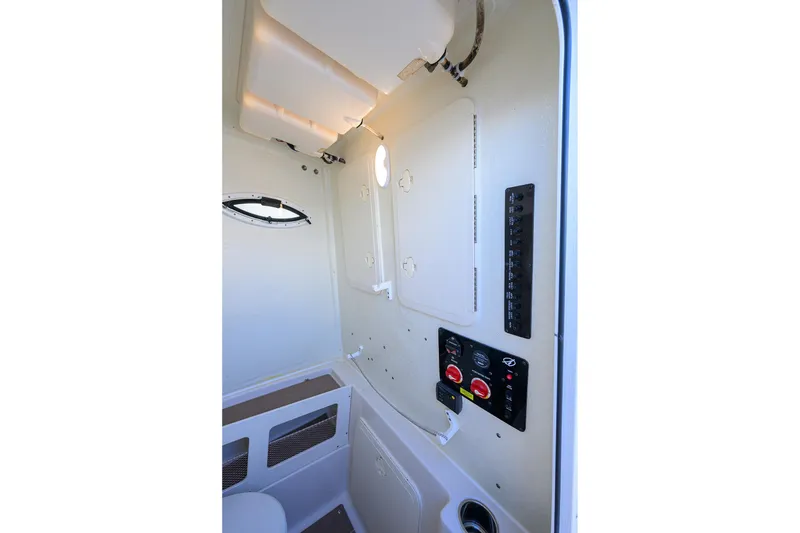 Slide: The Image of Interior view of 2022 Sailfish 242 CC boat's control panel and cabin features. - 20