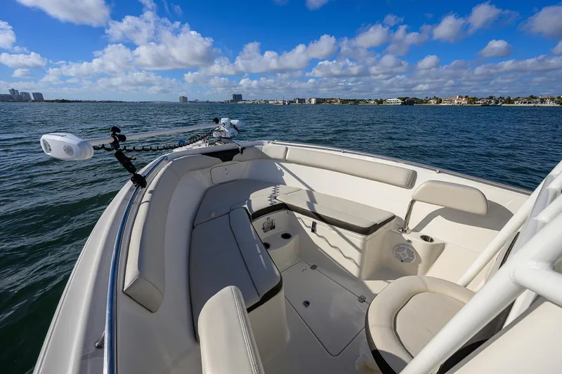 Slide: The Image of 2022 Sailfish 242 CC boat interior with seating, on a sunny day at sea. - 5