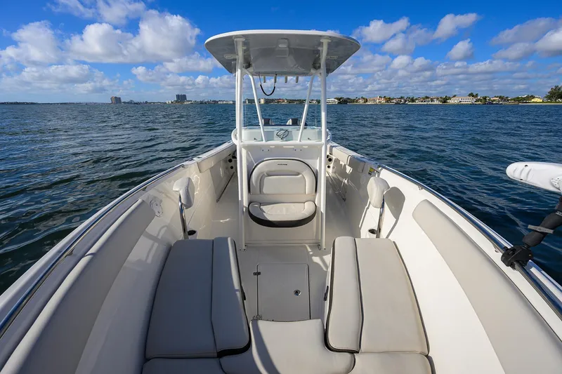 Slide: The Image of 2022 Sailfish 242 CC boat interior with seating, on a sunny day at sea. - 7