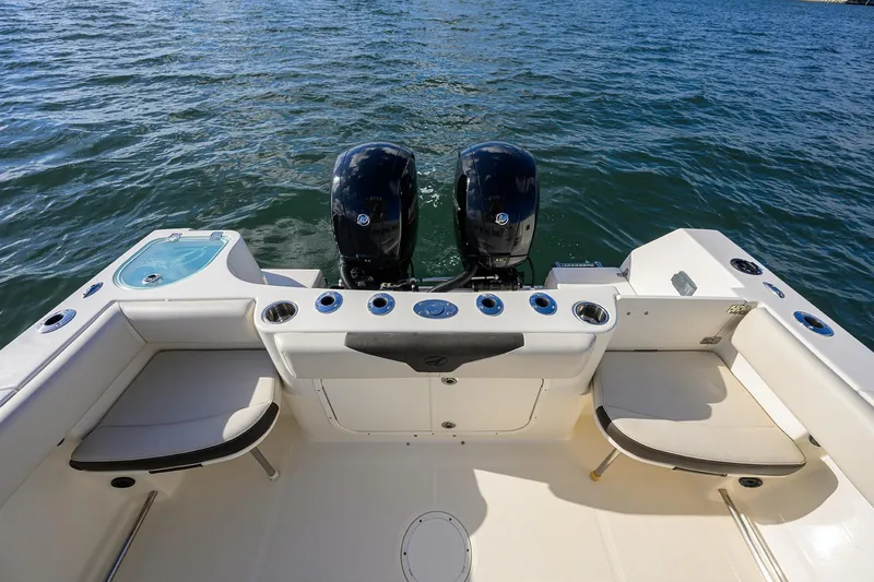 Slide: The Image of 2022 Sailfish 242 CC boat with dual engines and spacious seating on the water. - 8