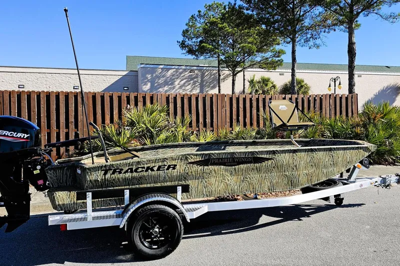 The Image of 2026 Tracker Grizzly 1650 T Prairie Wings Edition boat on trailer, outdoors. - 0