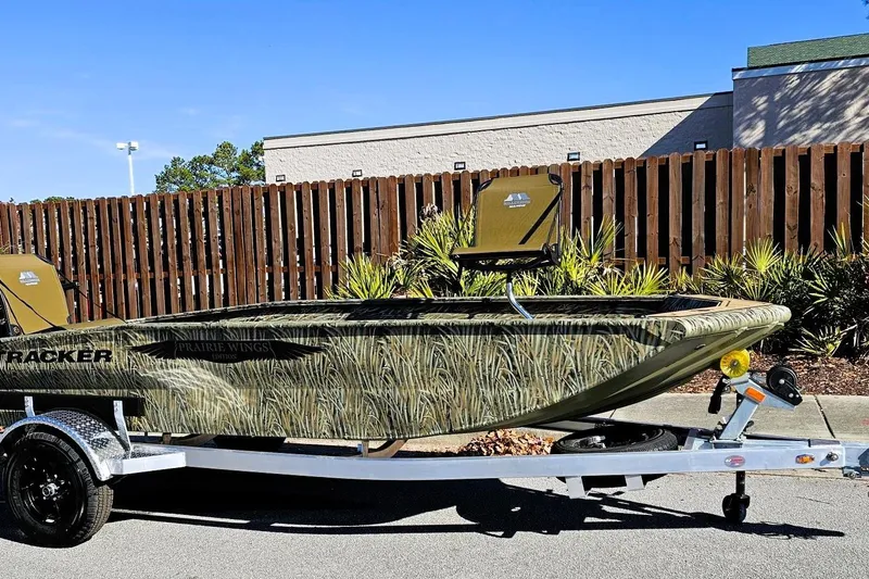 Slide: The Image of 2026 Tracker Grizzly 1650 T Prairie Wings Edition boat on trailer, camo design. - 2
